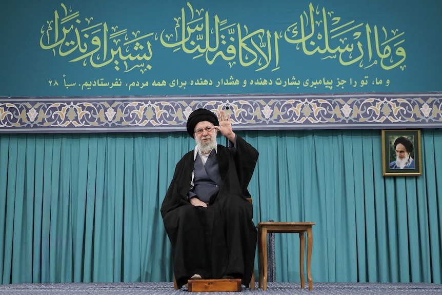 Supreme Leader of Iran Ayatollah Ali Khamenei sits on a chair.