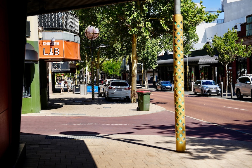 Cars parked in front of venues at an intersection in Northbridge 