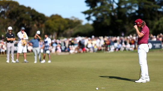 Cam Smith holds his head in his hands after missing the putt on 18.