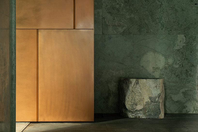 green marble clads gallery showroom’s immersive interiors in shenzhen