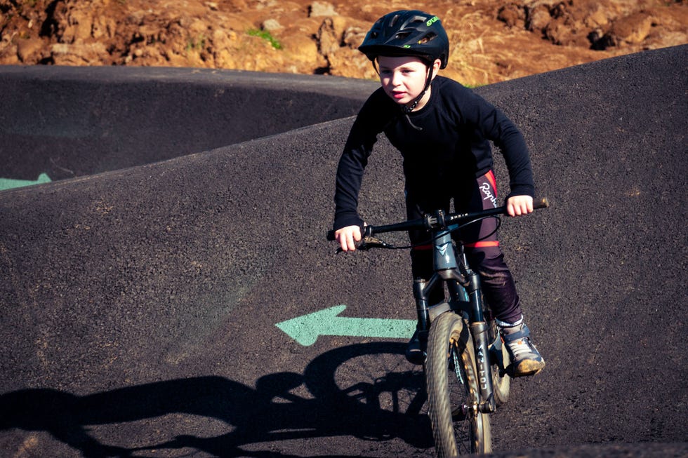 boy riding his bike on a pump track