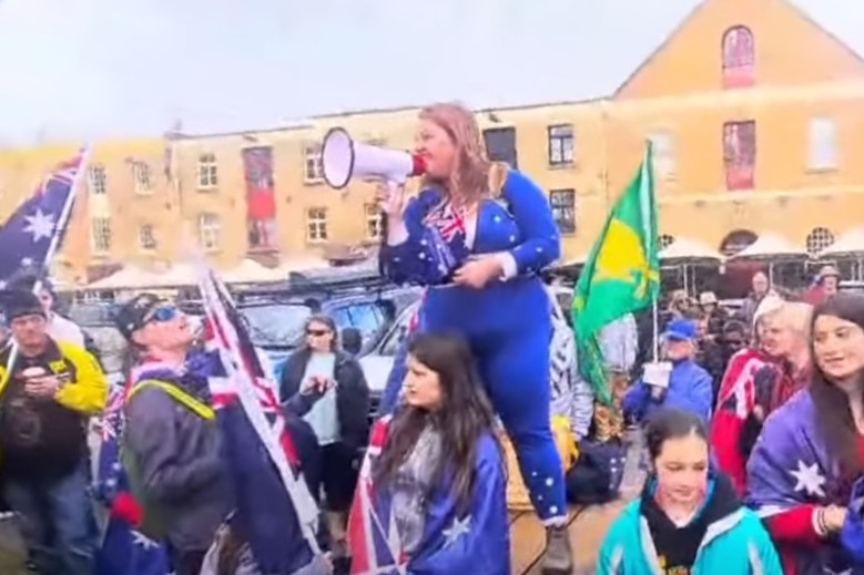 A woman with a megaphone speaking at a rally.
