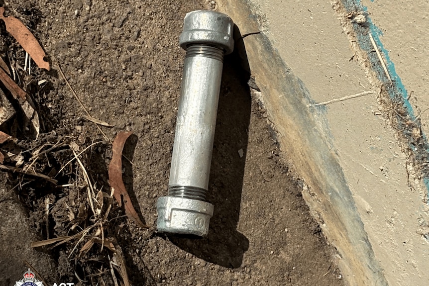 A close up of a silver pipe bomb