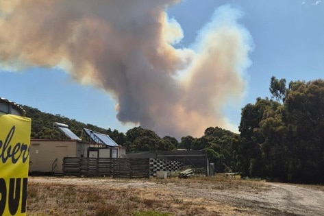 Smoke rises above a farm.