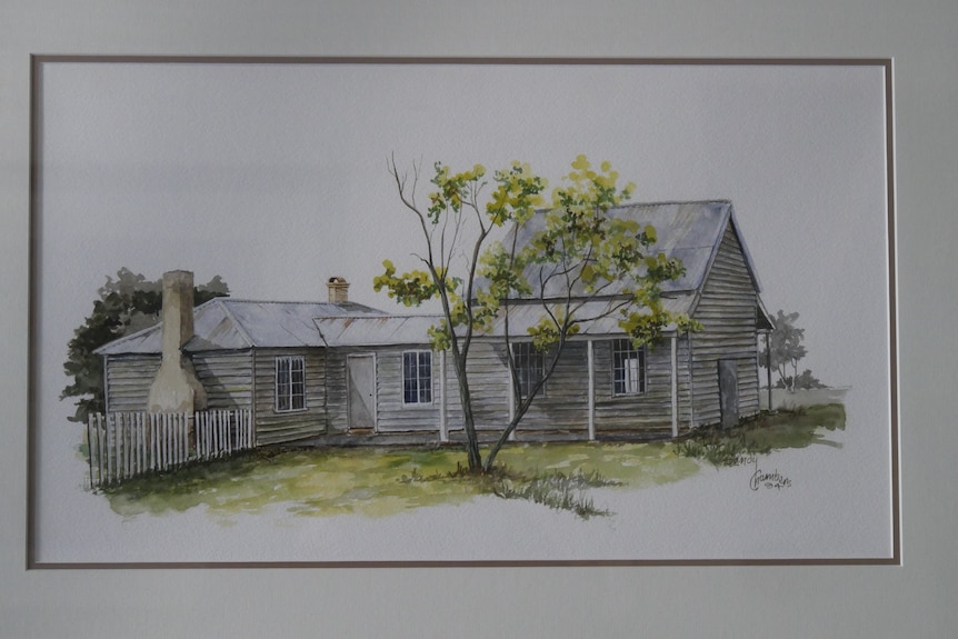 A framed painting of a white weatherboard house and green tree.