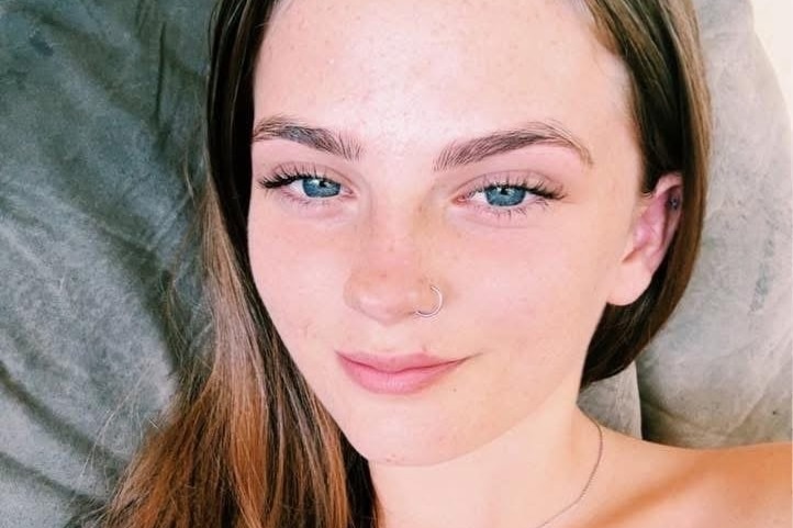 A girl with blue eyes and smiling at the camera