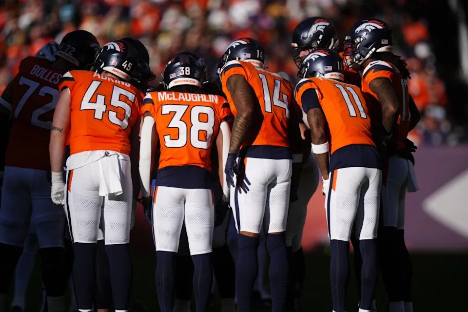 Dec 14, 2025; Denver, Colorado, USA; The Denver Broncos huddle during the first quarter against the Green Bay Packers at Empower Field at Mile High. Mandatory Credit: Ron Chenoy-Imagn Images