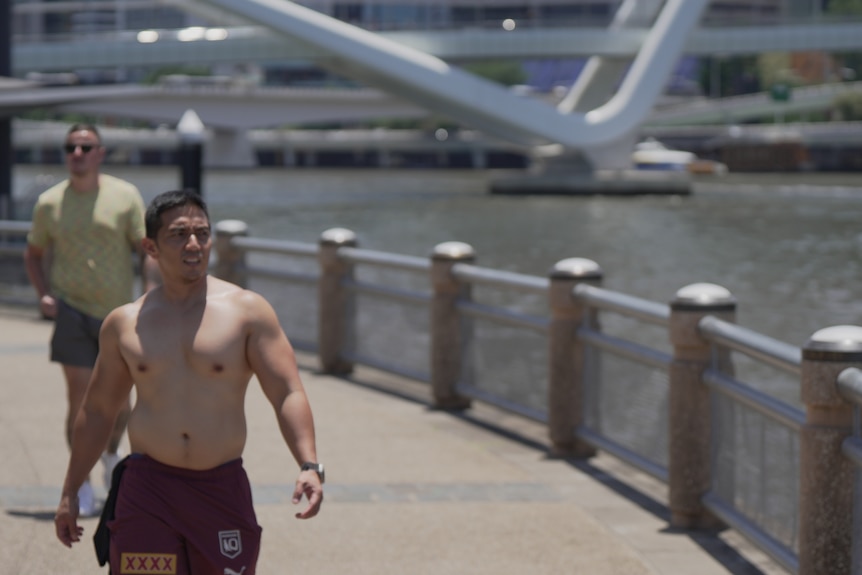 Man in shorts on boardwalk