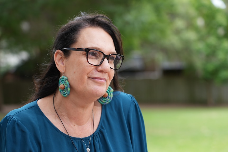 A close up of Kamilaroi woman Ali Tucker-Munro's face from the side as she smiles while listening. 