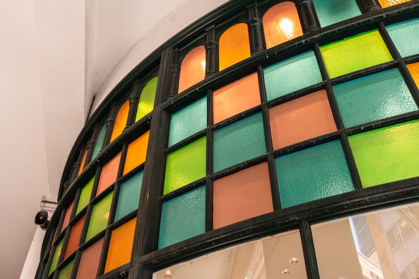 Red, green, blue and yellow glass along exterior of QVB