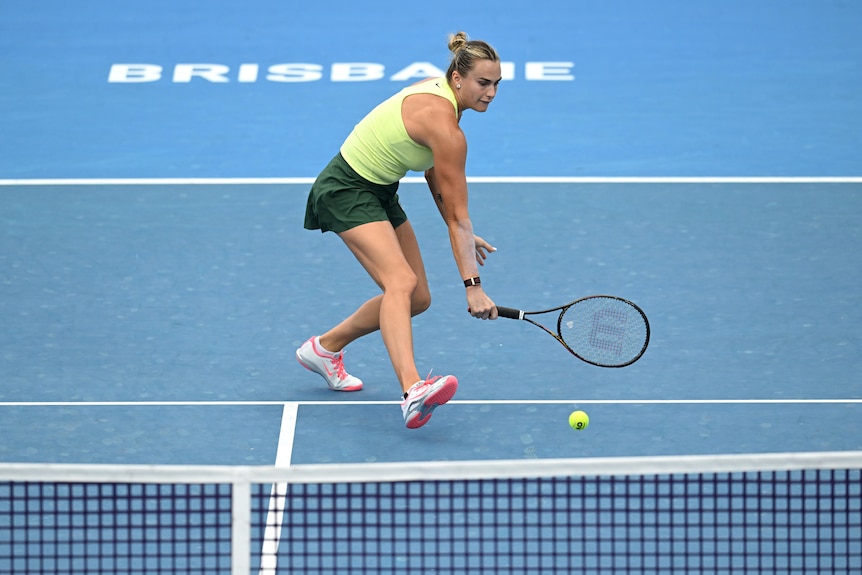Aryna Sabalenka hitting a tennis ball on court