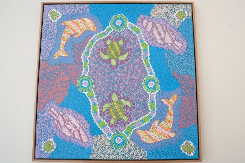 Aboriginal artwork with purple, blue, green and orange dots depicting turtles, dolphins and fish.