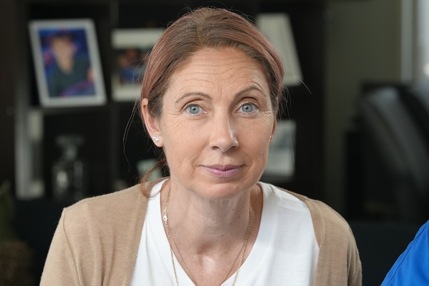 A woman with her hair tied back.