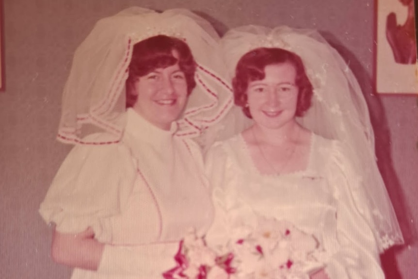A wedding picture - the bride and her bridesmaid - both in white