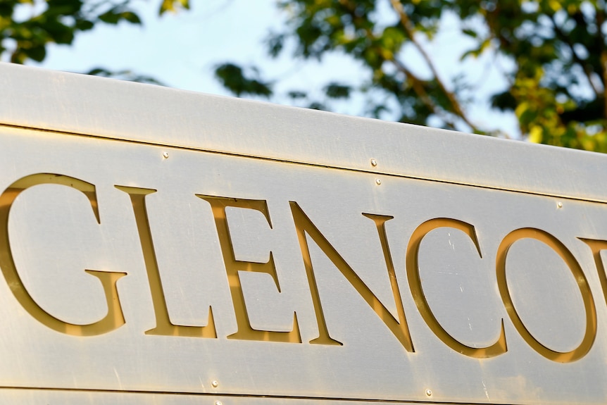 The logo of commodities trader Glencore is pictured in front of the company's headquarters