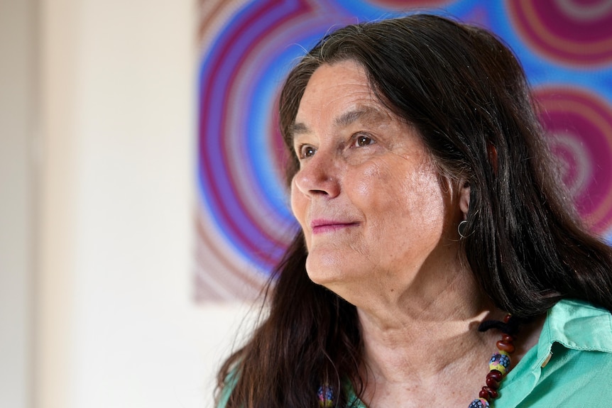 Woman looing up with painting