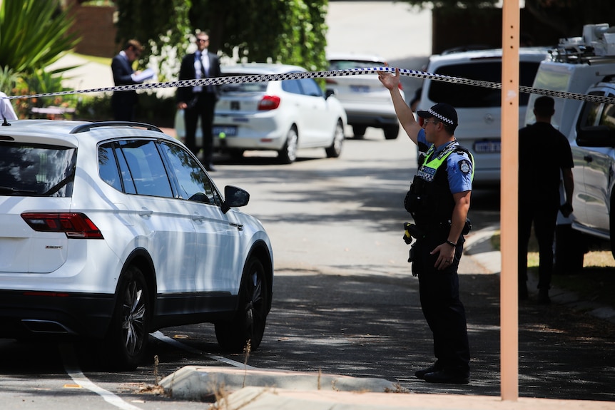 Police officers and vehicles on McCabe Street in Mosman Park. 