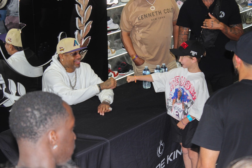 Allan Iverson fist bumps a young fan.