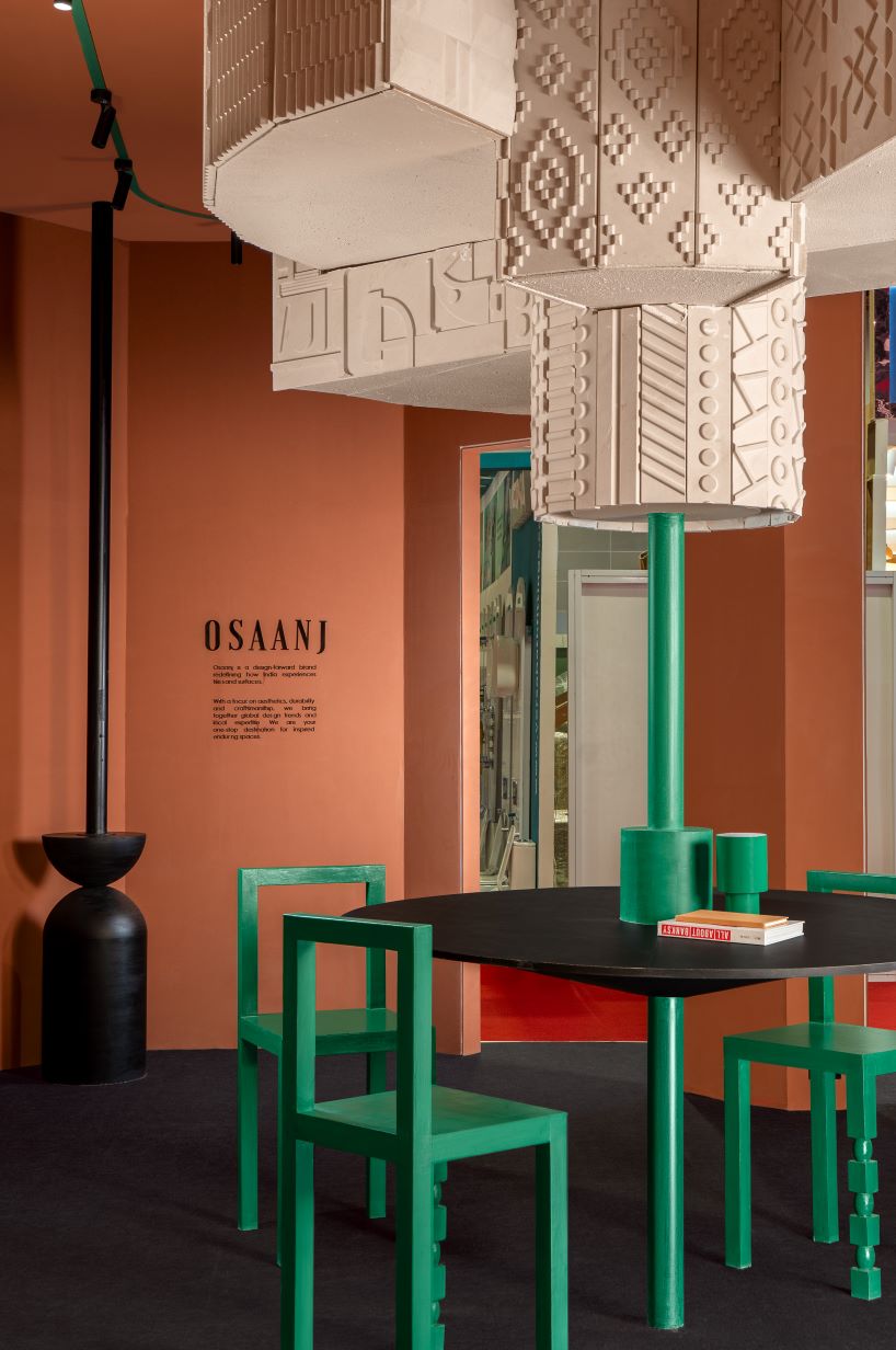 patterned tiles extend from curved walls to furniture in layered retail exhibition booth