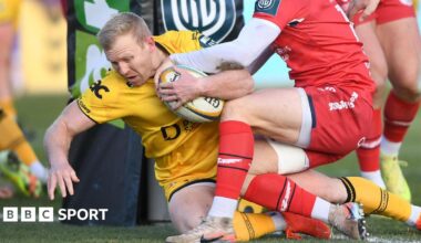 Dragons fly-half Tinus de Beer crashes over for a try against Scarlets