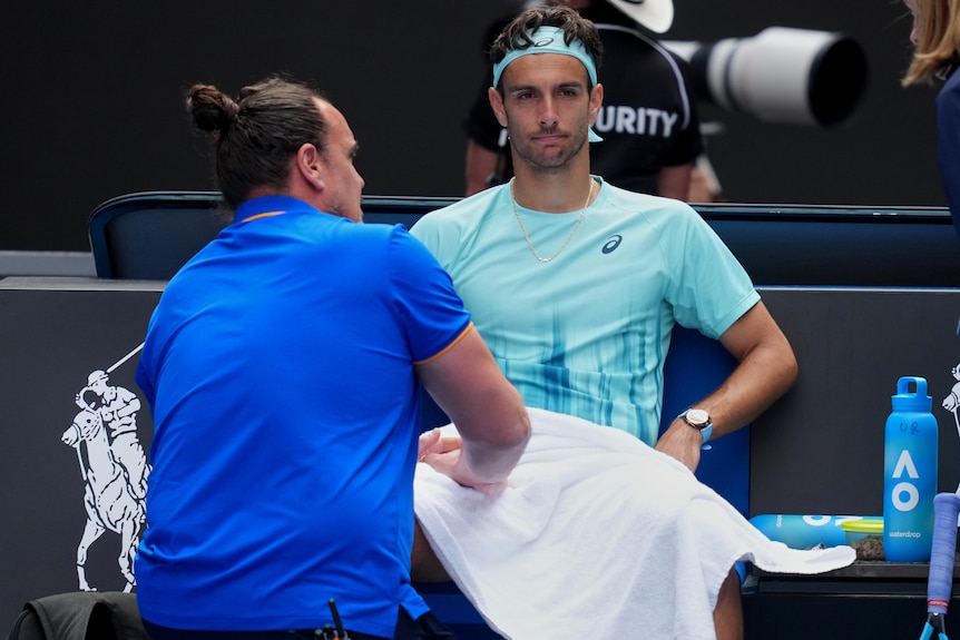 Lorenzo Musetti recieves treatment at Australian Open.