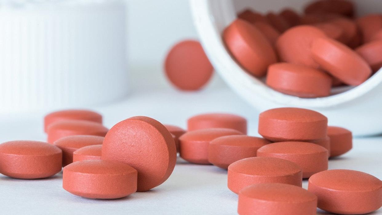 Ibuprofen tablets spilled from a bottle. - Michelle Lee Photography // Shutterstock