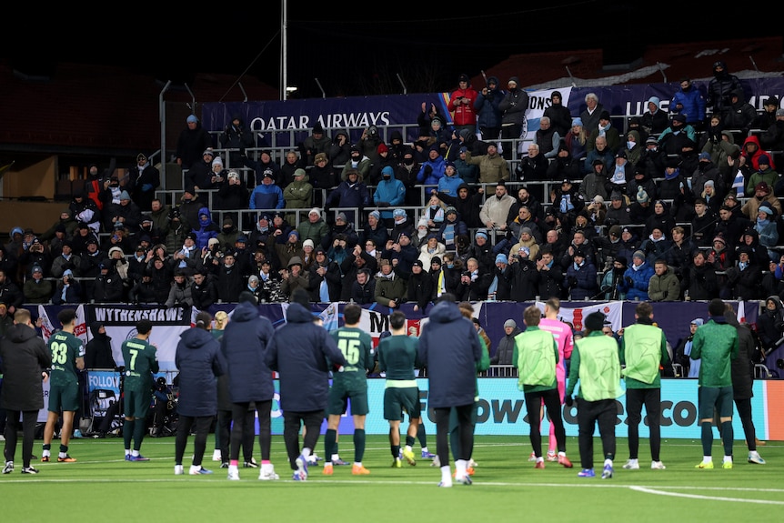 Manchester City fans at Bodo/Glimt look back at the players after the game