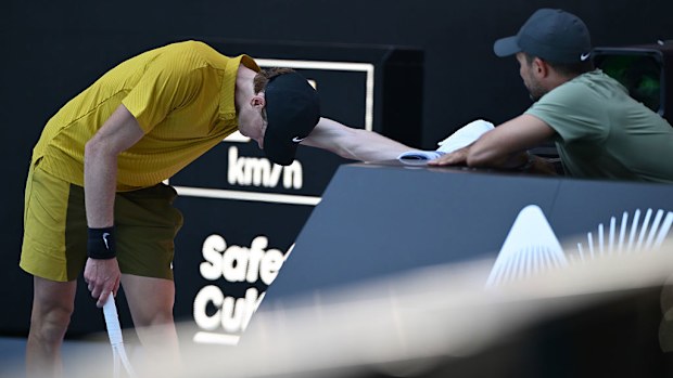 Jannik Sinner of Italy talks with his team members.