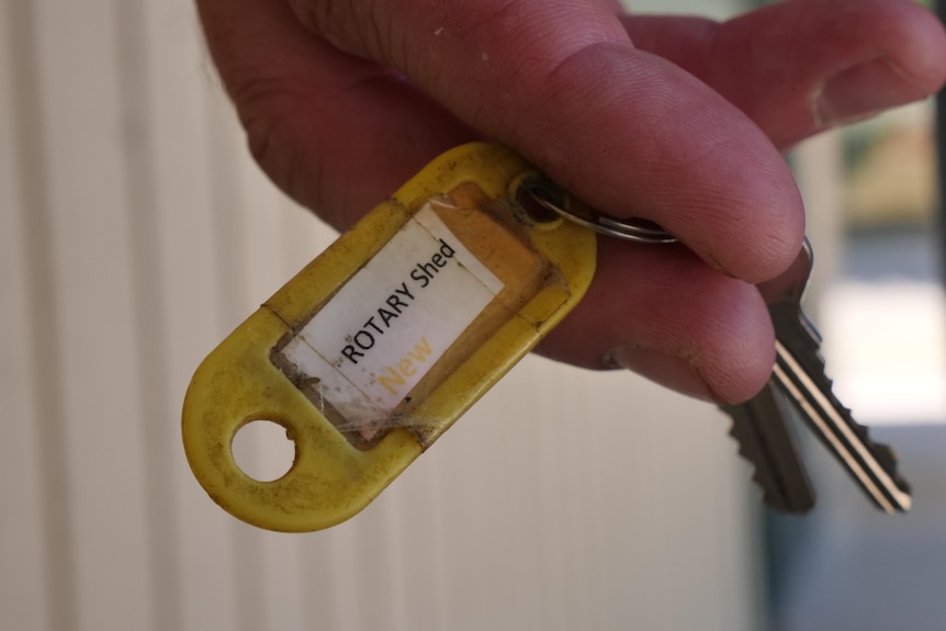 A ked held between fingers.