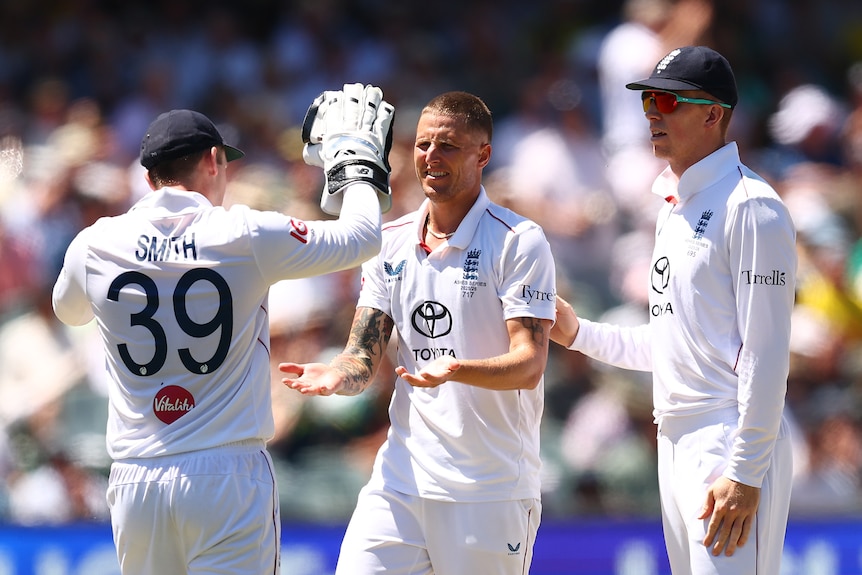England bowler Brydon Carse is congratulated by teammates Jamie Smith and Zak Crawley.