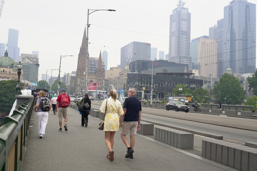 A man and waoman walk through the cbd