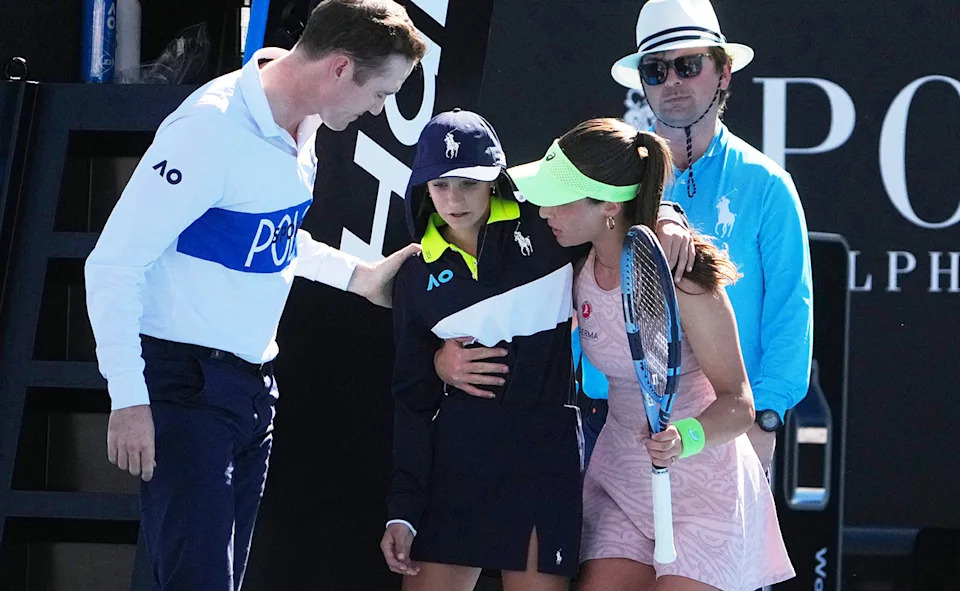 A ball kid is seen being helped off the court at the Australian Open.