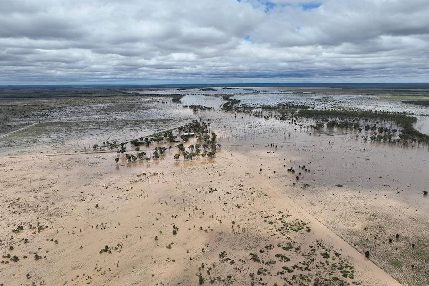 An aerial shot of a station surrounded by brown floowater.