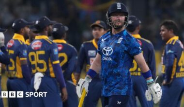 Ben Duckett walks off with celebrating Sri Lanka fielders in the background