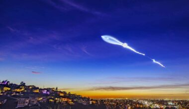 Bright rocket plume streaks across the twilight sky above a city, a reminder of rising launch activity and debris risk.