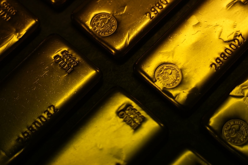 Gold bars stacked in rows.