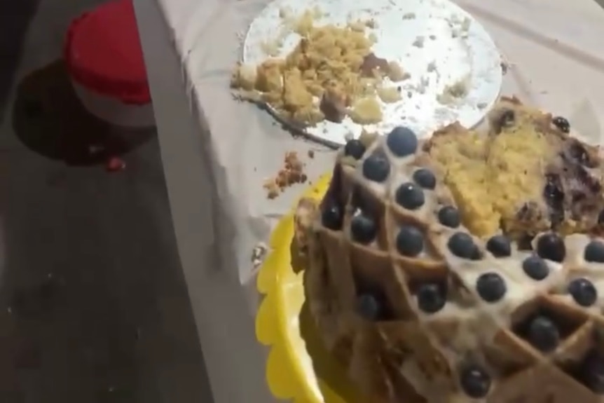 A shot of many half eaten cakes on a long table
