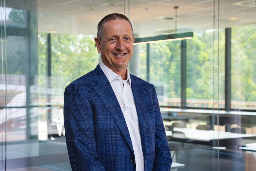 Ian Hickie stands in an office.