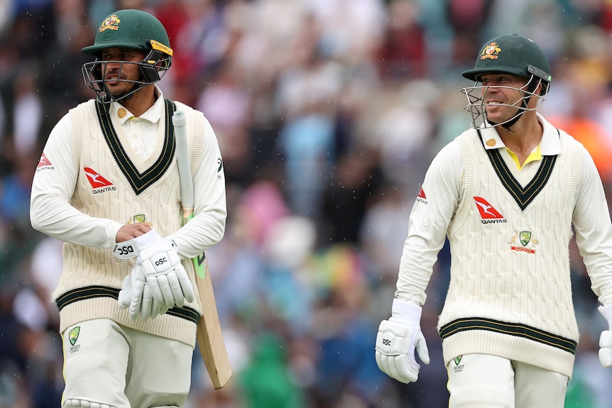 Australia batters Usman Khawaja and David Warner walk off the field at The Oval during an Ashes Test.