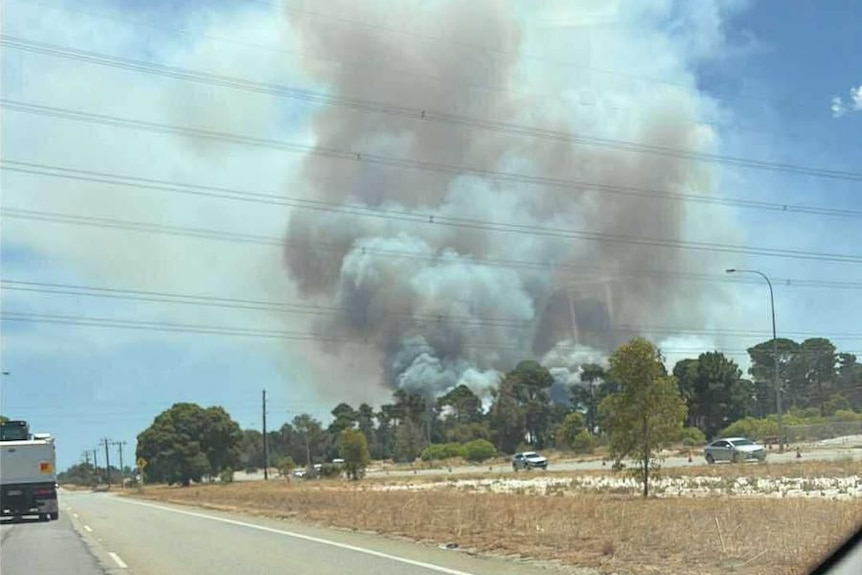 A large plume of white smoke is rising