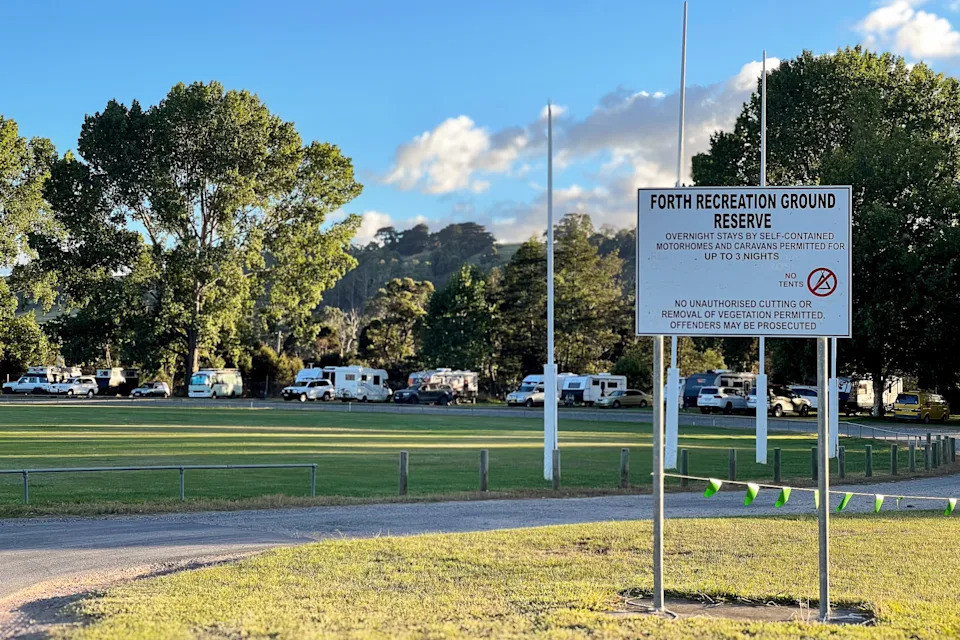 A sign in front of caravans parked at the Forth Recreation Ground.