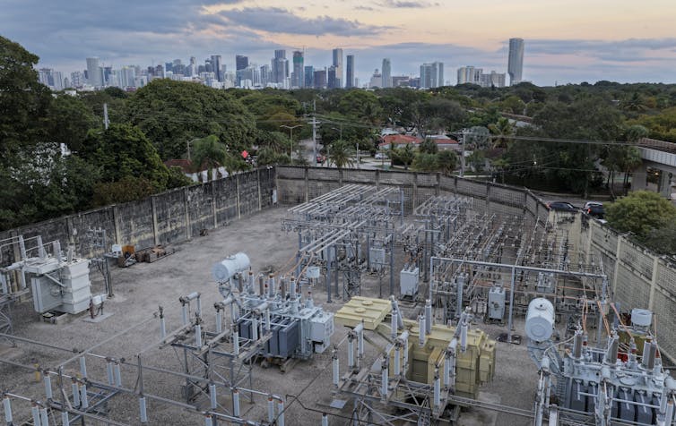 An overhead view shows a power substation with wires and equipment.