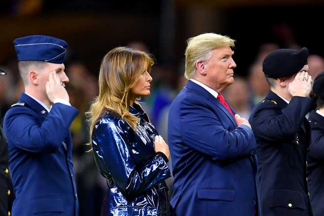 NEW ORLEANS, LOUISIANA - JANUARY 13: President Donald Trump and first lady Melania Trump took the field at the start of the College Football Playoff National Championship game between the LSU Tigers and the Clemson Tigers at the Mercedes Benz Superdome on January 13, 2020 in New Orleans, Louisiana. The LSU Tigers topped the Clemson Tigers, 42-25. (Photo by Alika Jenner/Getty Images)