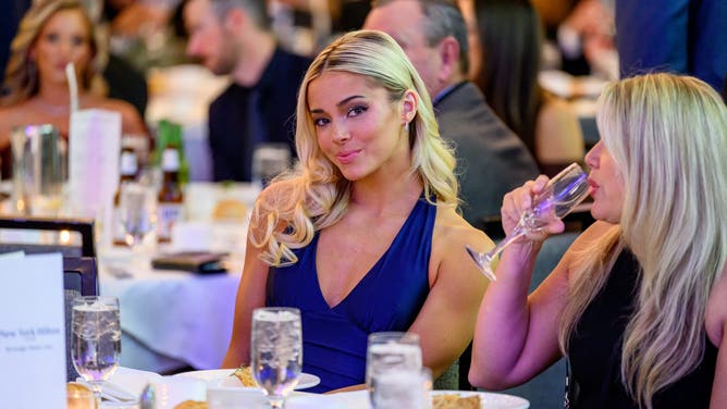 Livvy Dunne barefoot swing in golf simulator