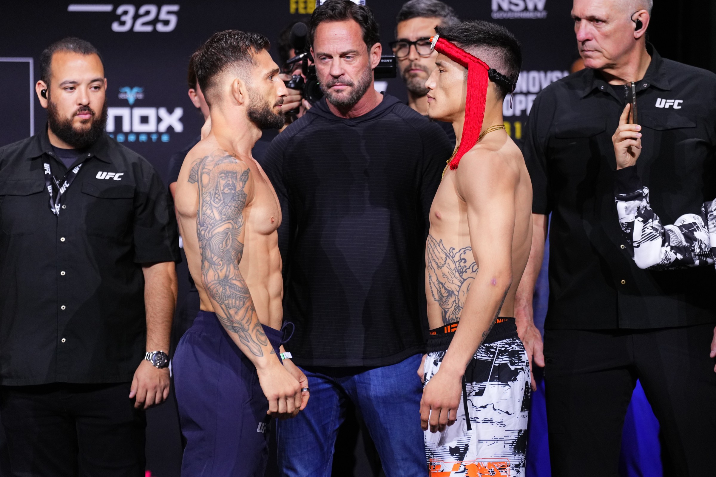 SYDNEY, AUSTRALIA - JANUARY 30: (L-R) Opponents Kaan Ofli of Australia and Yizha of China face off during the UFC 325 Ceremonial Weigh-in at Qudos Bank Arena on January 30, 2026 in Sydney, Australia. (Photo by Jeff Bottari/Zuffa LLC)