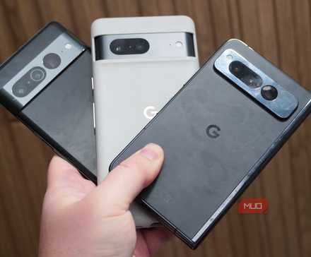 Holding a Google Pixel 7, Google Pixel 7 Pro, and Google Pixel Fold in the hand.
