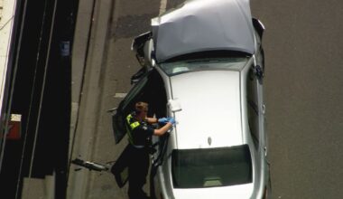 Man restrained by passersby after car crashes into multiple others on busy road