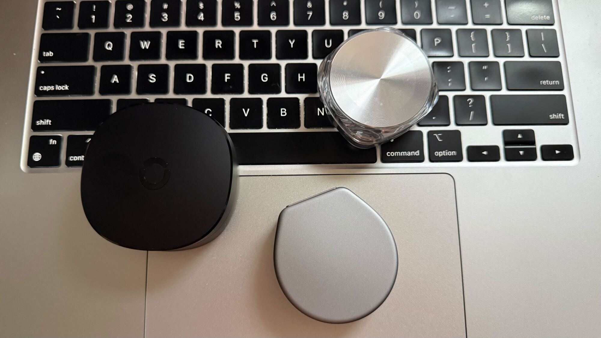 RingConn is the larger black case to the left. Oura is bottom right, Luna is top right.