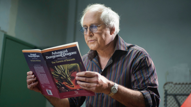 Pierce reading a Dungeons & Dragons book intently in Community