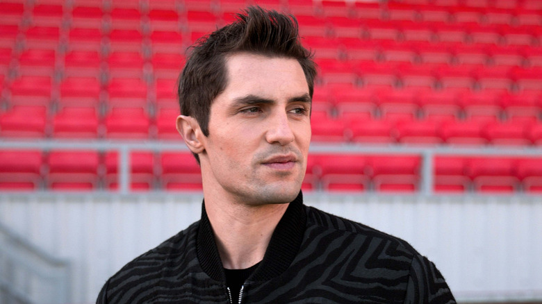 Jamie Tartt looking nonplussed in an empty football stadium in Ted Lasso